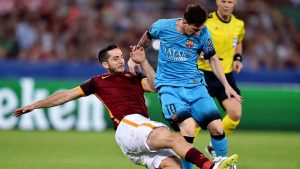 Roma's defender from Greece Kostas Manolas (L) tackles Barcelona's Argentinian forward Lionel Messi (R) during the UEFA Champions League football match between AS Roma and FC Barcellona at Rome Olympic stadium, on September 16, 2015. AFP PHOTO / ALBERTO PIZZOLI (Photo credit should read ALBERTO PIZZOLI/AFP/Getty Images)