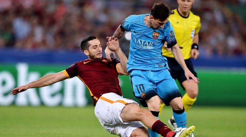 Roma's defender from Greece Kostas Manolas (L) tackles Barcelona's Argentinian forward Lionel Messi (R) during the UEFA Champions League football match between  AS Roma and FC Barcellona at Rome Olympic stadium, on September 16, 2015.  AFP PHOTO / ALBERTO PIZZOLI        (Photo credit should read ALBERTO PIZZOLI/AFP/Getty Images)